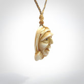 Hand carved incredible stained bone gargoyle face carving. A stunning work of art. This pendant was hand carved in bone with buffalo horn inlay for the eyes by Yuri Terenyi. A one off collectors item that has been hand crafted to be worn or displayed.